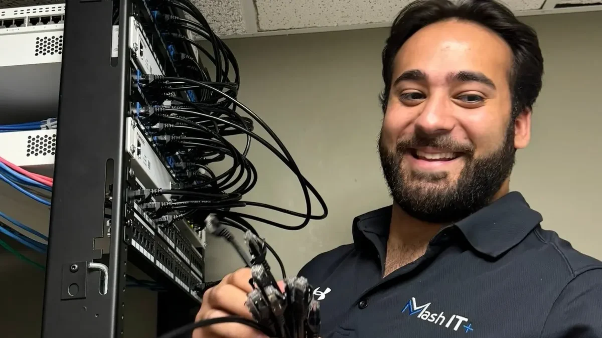 Jason Mashni of Mash IT patching network cables into a client's server rack